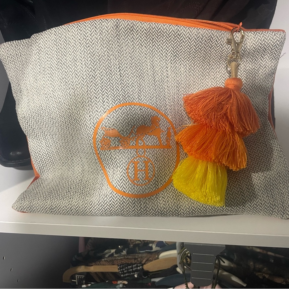 Canvas Pouch with H detail. Orange suede back. Tassel zipper closure